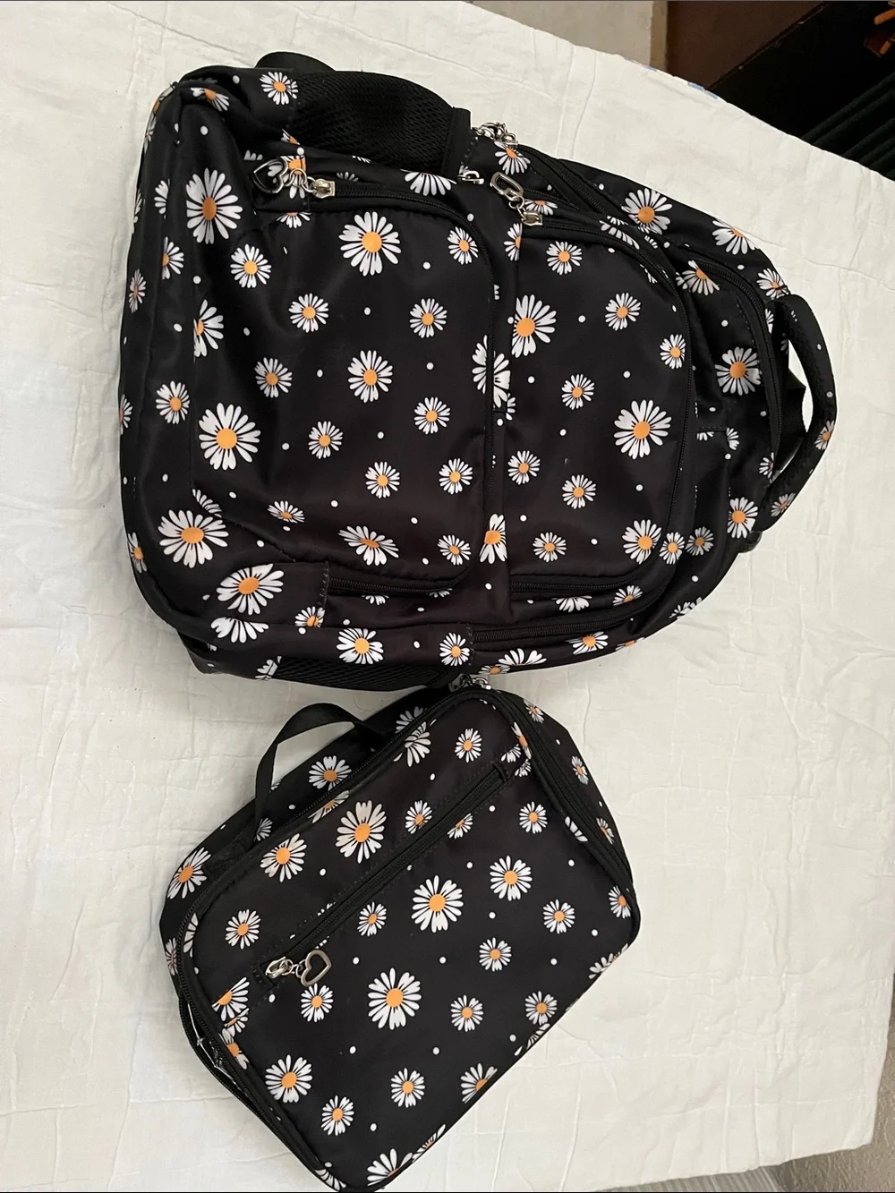 Black Daisy Print Backpack and insulated lunch bag.